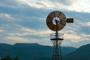 Windmill on a metal mast photo