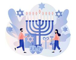 Hanukkah concept. Traditional jewish holiday with tiny people and symbols - menorah candles, dreidels spinning top, star David. Modern flat cartoon style. Vector illustration on white background