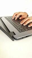 Young woman's finger is pressing a laptop keyboard key. photo