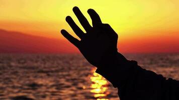 Man Hand Finger Touching the Sun at Sea Sunset video