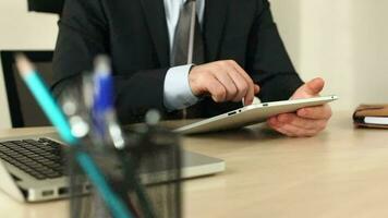 Businessman using tablet in office video