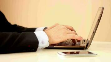 Businessman using tablet computer using keyboard typing fast, businessman sends message in office workplace, selective focus video