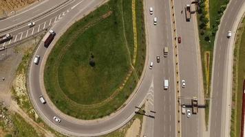 Aerial view of vehicles and traffic on highway, vehicles exiting highway moving towards bridge with light traffic in metropolitan city, selective focus, Istanbul Turkey video