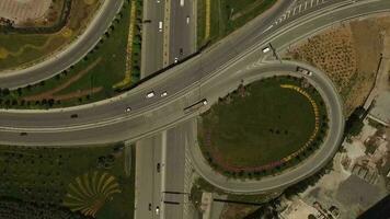 Aerial view of vehicles in city traffic and highway, vehicles exiting highway and moving towards bridge, selective focus, Istanbul, Turkey video