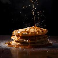 Pancakes with caramel sauce on a black background. Toned., Image photo