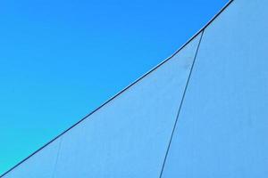 modern original fragments of architecture against the blue sky creating an interesting background photo