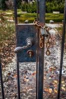 old retro vintage door fence with a large lock closed on a chain photo