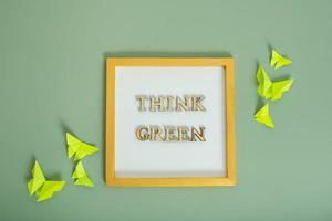 Environment for the future, concept of saving the planet. Think green text with paper butterflies photo