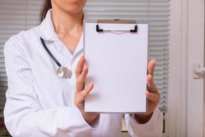 Blank tablet mockup in doctor hand with stethoscope. Healthcare and medicine mock up for text photo