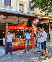 Istanbul, Turkey on July 2022. Two Turkish men standing in front of a TAMARA restaurant. One of the restaurants usually visited by tourists from outside Turkey for lunch in groups. photo