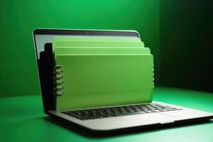 File folder on laptop screen with a green background created with technology. photo
