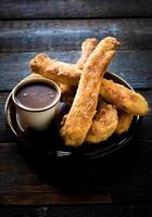 Spanish churros with chocolate photo