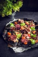 Black homemade pizza photo