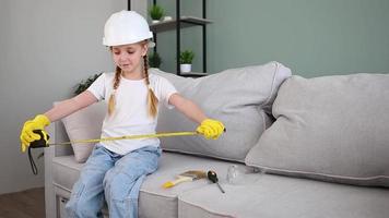 A child in construction overalls. Construction of houses. Home renovation. video