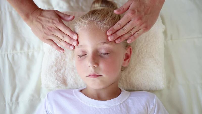 Masseur doing face massage to child. 23193401 Stock Video at Vecteezy