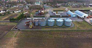 aerial view over agro-industrial complex with silos and grain drying line video