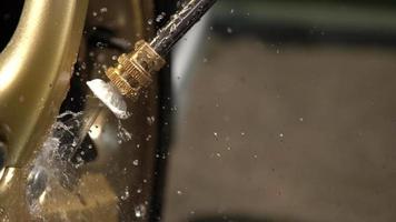 water jet cleaning chromium bolt on golden wheel video