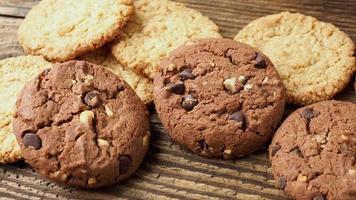 Various tasty cookies biscuits on wooden background video