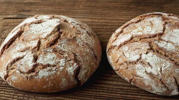 Delicious baked bread on a wooden background video