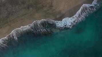 Aerial view of the desert black beach on the Atlantic Ocean. Coast of the island of Tenerife, Canary Islands, Spain. Aerial drone footage of sea waves reaching shore. video