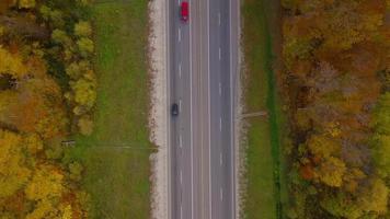 Aerial view of the road and the river near the autumn forest. Scenic autumn landscape video