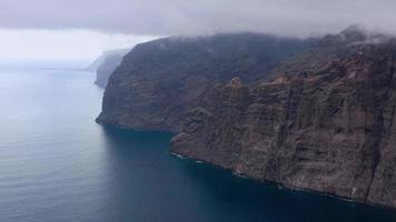 antenne visie van los gigantes kliffen Aan Tenerife in bewolkt het weer, kanarie eilanden, Spanje. versneld video