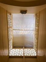 The ceiling is viewed from below in a room with a dominant cream color. photo