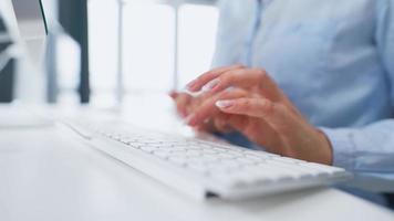 Woman enters credit card number on computer keyboard. Woman making online purchase. Online payment service. Close up of woman hands hold credit card and using computer for online shopping video