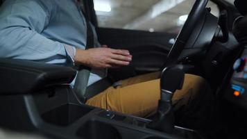 Man driving in innovative automated car using self-parking autopilot for parking on parking lot. Robotic computer turning wheel in autosteering mode video