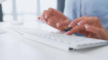 Woman enters credit card number on computer keyboard. Woman making online purchase. Online payment service. Close up of woman hands hold credit card and using computer for online shopping video