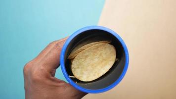 hand pick chips from a plastic container top view video