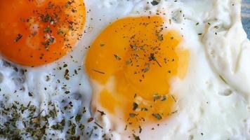 Fried eggs in the plate close up , video