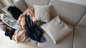 Messy clothes on sofa at home video