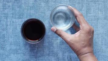 comparing soft drinks with glass of water on table video