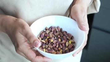 Shelled pistachio in a bowl on table , video