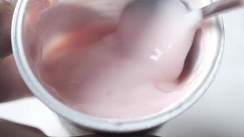 detail shot of spoon pick fresh yogurt in a bowl on table video