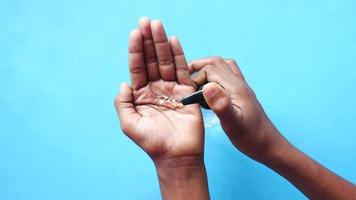 mans hands using hand sanitizer gel, close up video