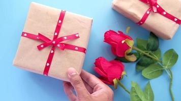 Top view of man s hand holding a gift box on table video