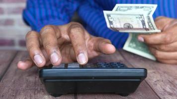 Close up of man hand using calculator and holding cash video