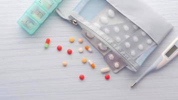 Close up of colorful pills, blister pack, and medicine spilling from contianer video