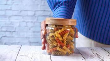 Man hand taking dry Italian pasta from a jar video