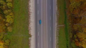 Aerial view of the road and the river near the autumn forest. Scenic autumn landscape video