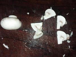 Cooking and cutting champignon mushrooms photo