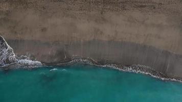 Aerial view of the desert black beach on the Atlantic Ocean. Coast of the island of Tenerife, Canary Islands, Spain. Aerial drone footage of sea waves reaching shore. video