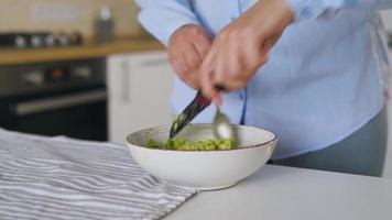 Time lapse of preparation avocados for use - separates the pulp from the skin with a spoon. Healthy vegan breakfast video