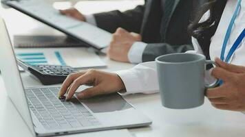 Financial analysts analyze business financial reports on a digital tablet planning investment project during a discussion at a meeting of corporate showing the results of their successful teamwork. video
