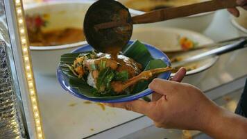 a serving of rice, eggs, chicken, gravy in a bowl and a glass of cucumber drink photo