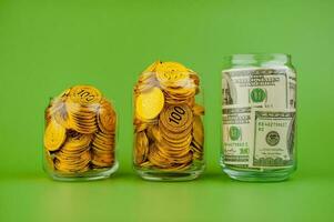 gold coins in a glass jar Gold savings concept. Lots of gold. Gold stocks. photo