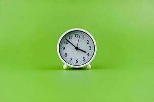 alarm clock on green background time concept working with time precious time photo