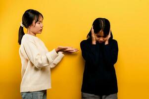 the intensity of communication misunderstanding Two friends don't talk to each other after a fight. behind the yellow background Filming of content about conflicts and misunderstandings photo